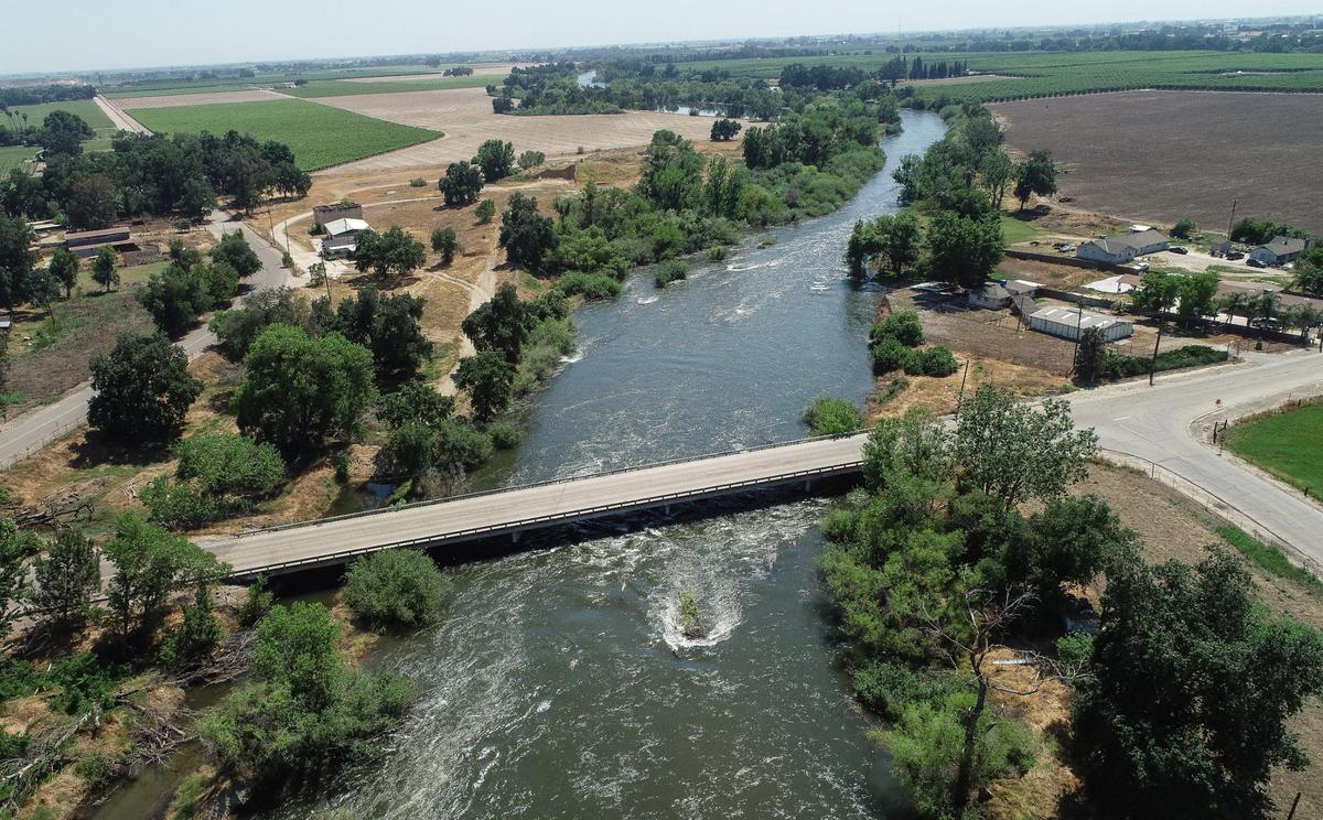 The Kings River flows south at a high rate near the Annadale Avenue bridge east of Sanger in eastern Fresno County on Wednesday, May 17, 2023.