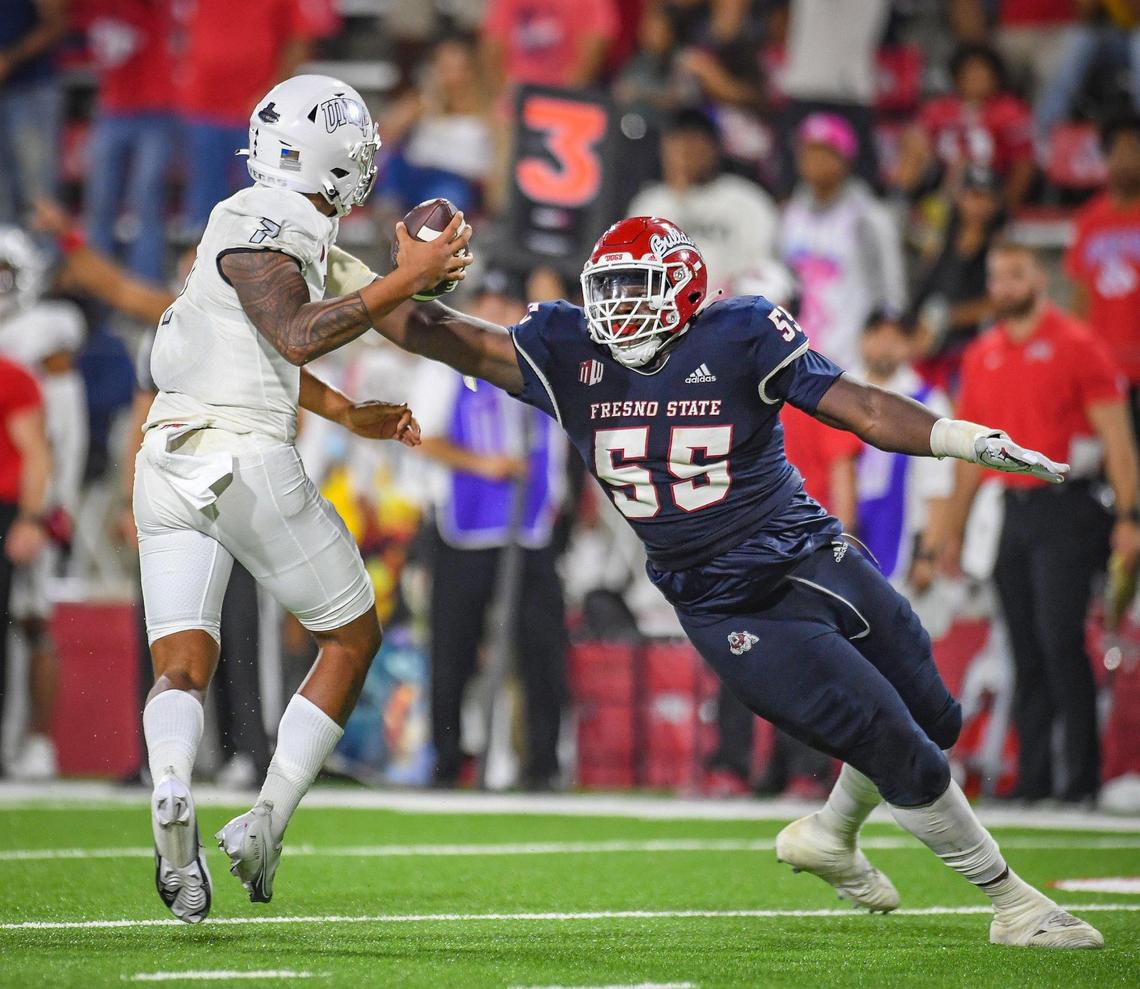 Fresno State defensive tackle Leonard Payne puts pressure on UNLV quarterback Cameron Friel during their game at Bulldog Stadium on Friday, Sept. 24, 2021.