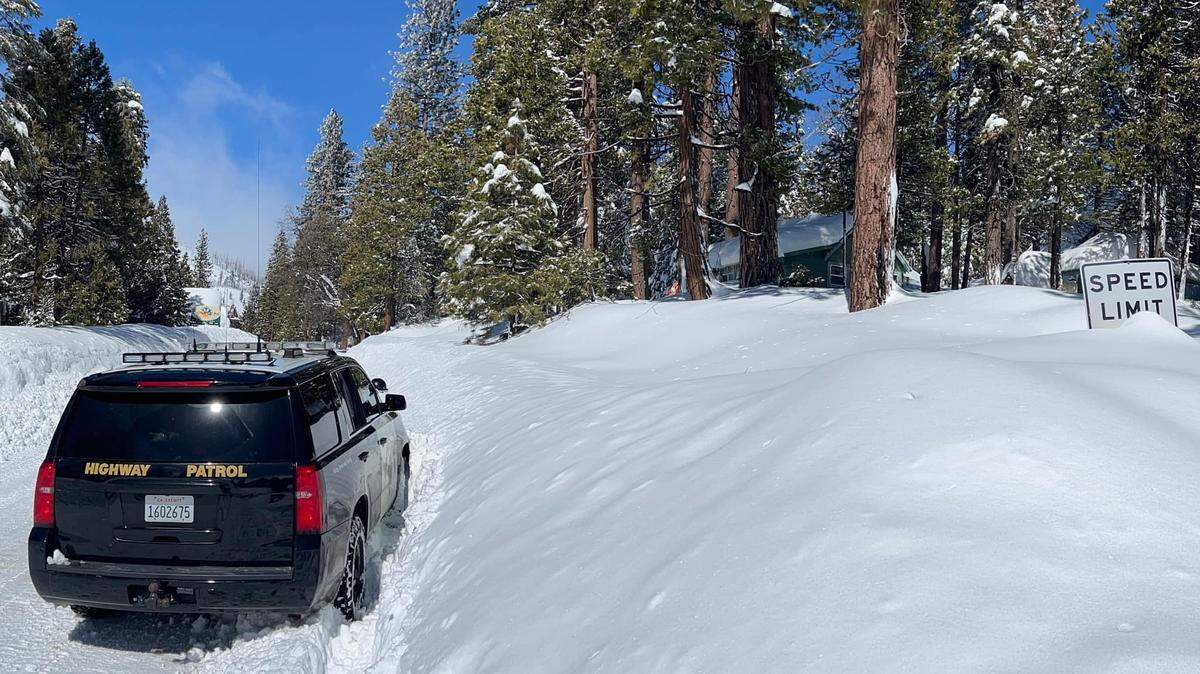 A CHP cruiser approaches Shaver Lake, California, in eastern Fresno County in a photo posted to social media on Wednesday, March 1, 2023. Shaver Lake has been shut off to traffic since Highway 168 was closed Friday, Feb. 24, 2023, due to snow and ice conditions.