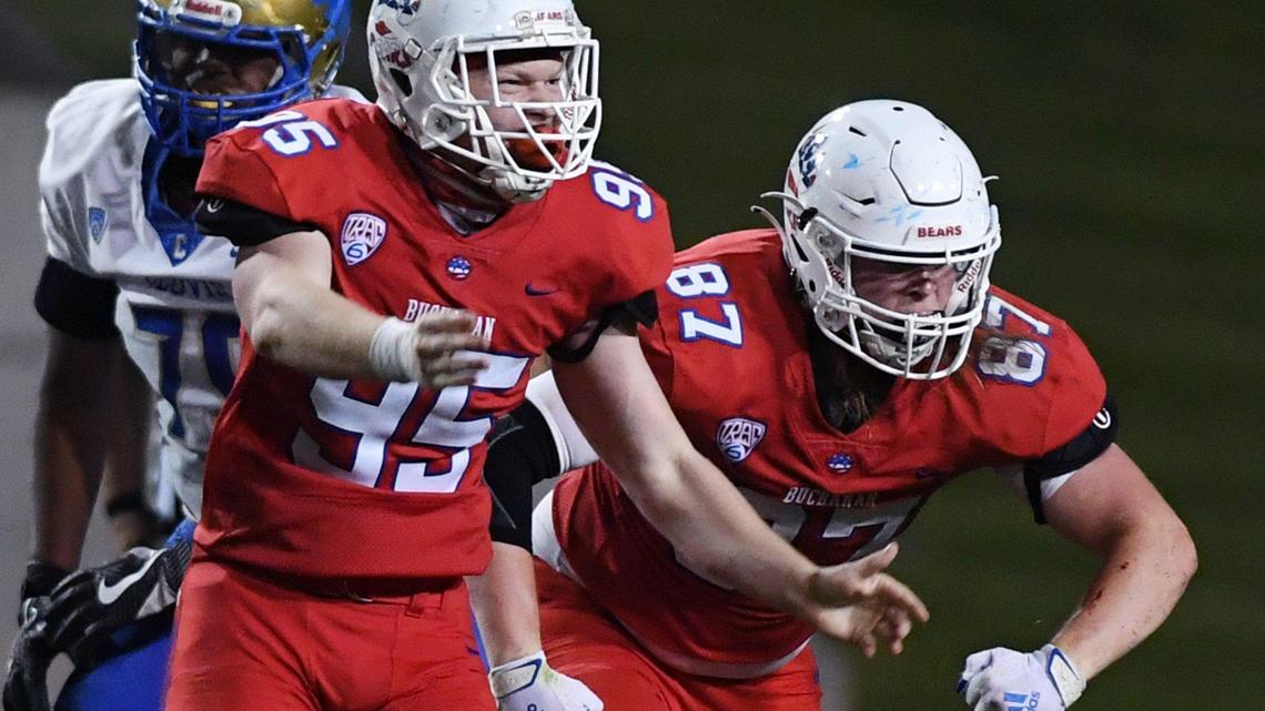 Buchanan’s Drew Washburn, left, and Gavin Nelson, right celebrate sacking Clovis quarterback Nate Johnson Thursday, April 1, 2021 in Clovis. The Bears are outright Tri-River Athletic Conference champions.