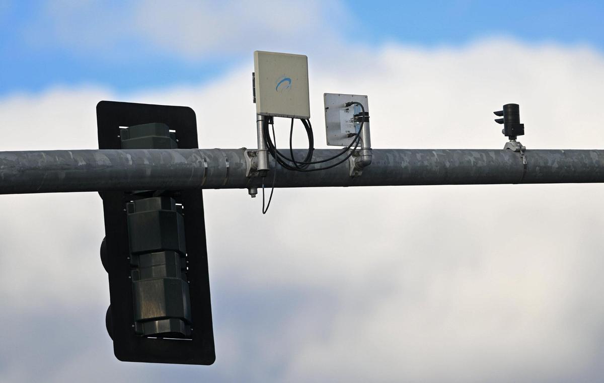Devices are seen clamped to traffic light poles at Blackstone and Clinton avenues Thursday, Oct. 31, 2024 in Fresno.