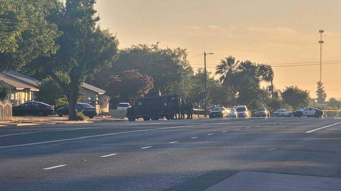 Fresno police surround a home and use an armored vehicle for cover during a standoff near West Shields and North Delno avenues on Monday, Aug. 2, 2021.