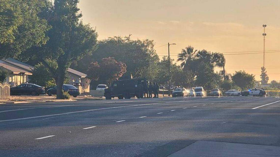 Fresno police surround a home and use an armored vehicle for cover during a standoff near West Shields and North Delno avenues on Monday, Aug. 2, 2021.