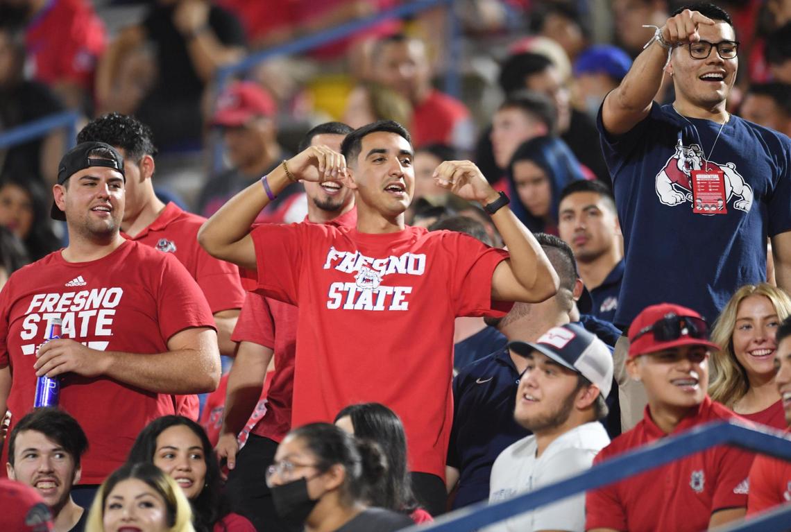 Students in the Fresno State student section cheer on the Bulldogs during their game against UNLV at Bulldog Stadium on Friday, Sept. 24, 2021.
