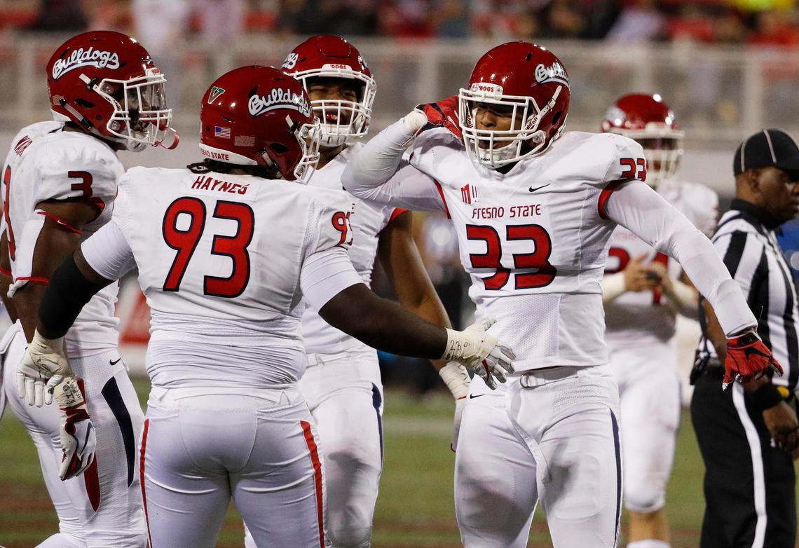 Fresno State defensive end Kwami Jones (33) celebrates with defensive tackle Jasad Haynes (93) after sacking UNLV quarterback Max Gilliam in the Bulldogs’ 48-3 victory at Sam Boyd Stadium in Las Vegas Saturday, Nov. 3, 2018.