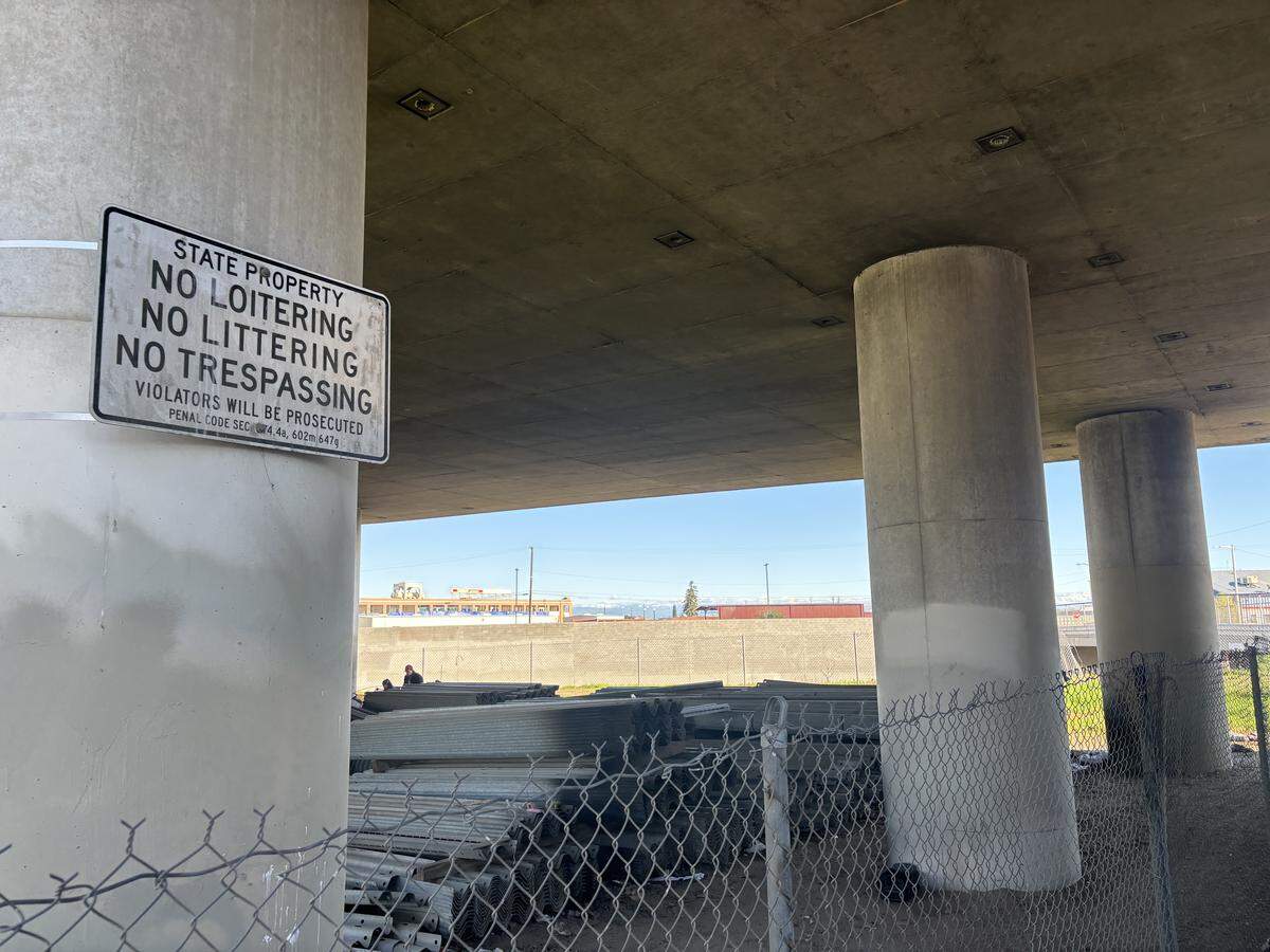 A sign warns against trespassing under Highway 41 on California Ave in Fresno photographed Jan. 6, 2026. An unhoused woman was cited by Fresno PD at the site for violating the city’s anti-camping ordinance on the morning May 15, 2025.
