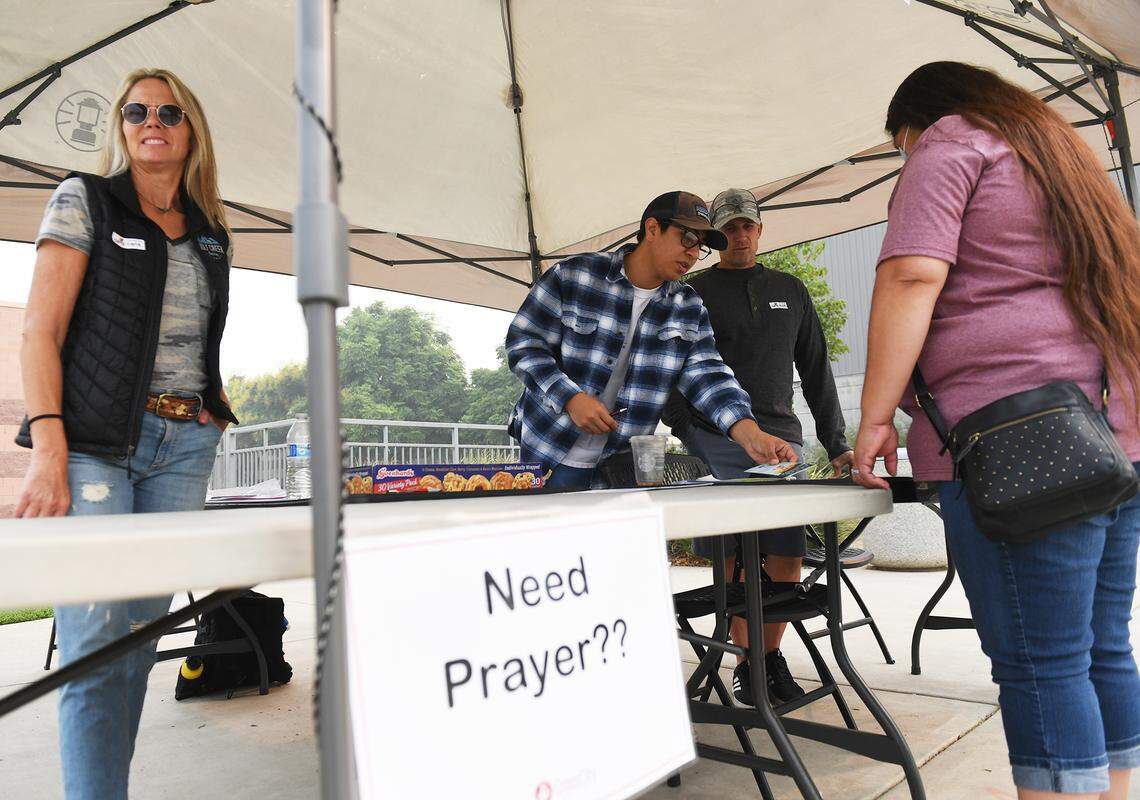 Tammy Walker, far right, from Big Sandy Rancheria, seeks services from the Red Cross and other agencies at Granite Ridge gymnasium Monday, Sept. 14, 2020 in Clovis.