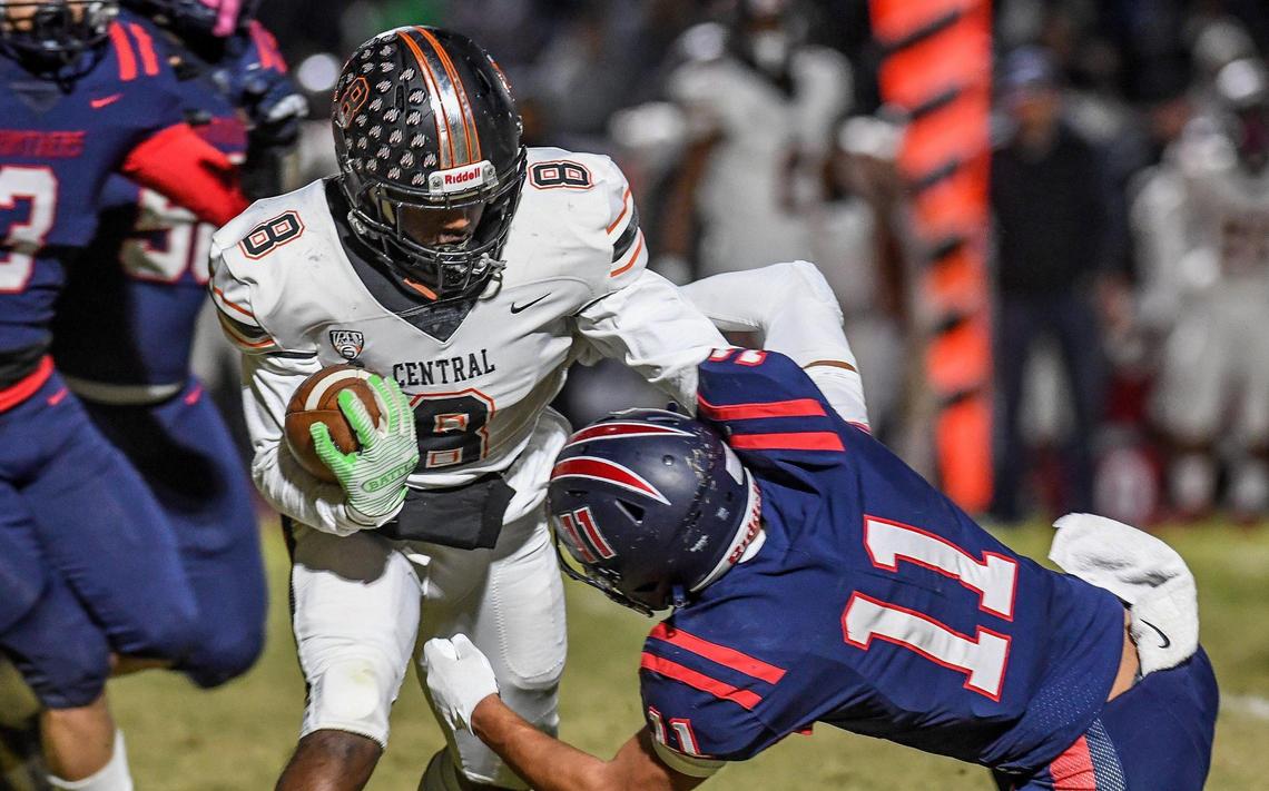 Central’s Michael James, left, tries to get by Memorial’s Jayden Enriquez on a run in the first half of their quarterfinal playoff game at San Joaquin Memorial on Thursday, Nov. 10, 2022.