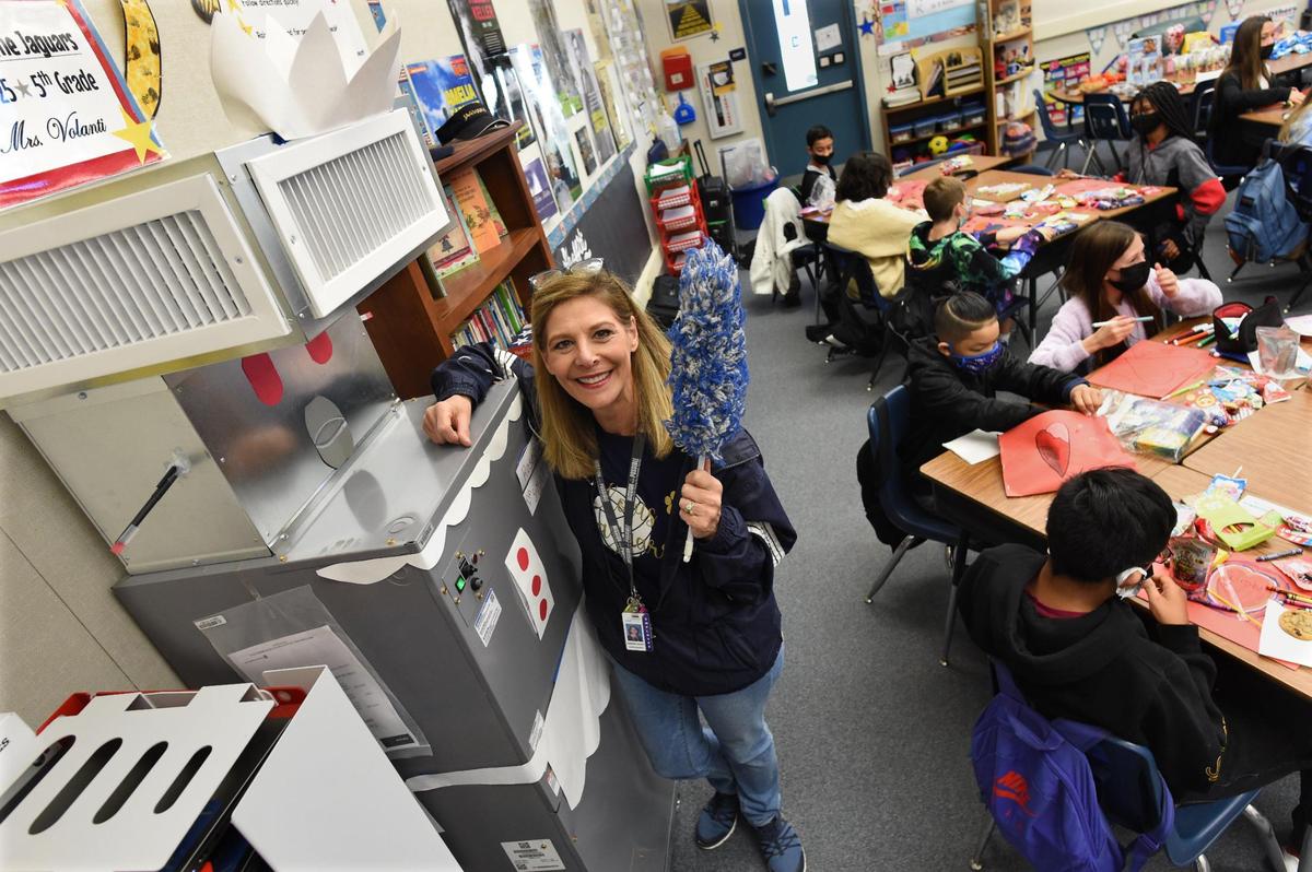 Clovis Elementary School fifth grade teacher Tina Volanti shows the HEPA-grade Carrier air filtration unit nicknamed “Rosie,” the robot maid from the 1960’s cartoon series “The Jetsons,” her students decorated. The system is installed in nearly every indoor space in Clovis Unified. Students help decorate the devices, which helps safeguard their health, by decorating them that helps safeguard their health.