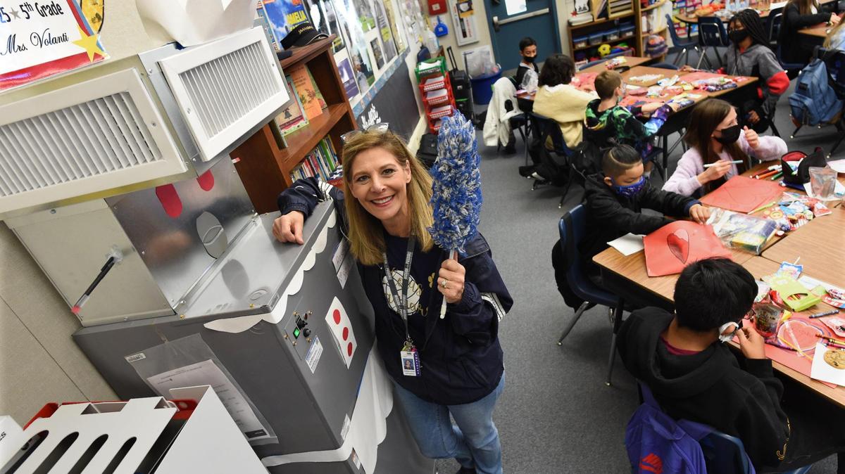 Clovis Elementary School fifth grade teacher Tina Volanti shows the HEPA-grade Carrier air filtration unit nicknamed “Rosie,” the robot maid from the 1960’s cartoon series “The Jetsons,” that her students decorated. The system is installed in nearly every indoor space in Clovis Unified. Students help decorate the devices, which helps safeguard their health.