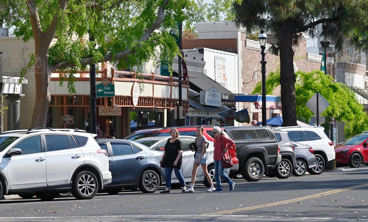 Pedestrians cross Pollasky Ave. Wednesday, March 26, 2025 in Old Town Clovis. Cowboy Cleanup will bring one hundred volunteers together to clean the streets, shops and intersections of Old Town Clovis on Saturday, March 29 in preparation for rodeo events in April.
