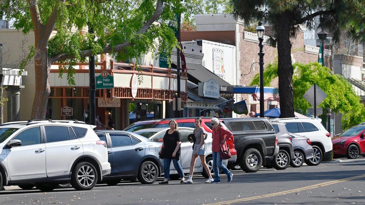 Pedestrians cross Pollasky Ave. Wednesday, March 26, 2025 in Old Town Clovis. Cowboy Cleanup will bring one hundred volunteers together to clean the streets, shops and intersections of Old Town Clovis on Saturday, March 29 in preparation for rodeo events in April.