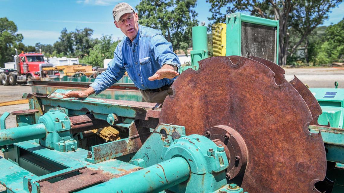 Kirk Ringgold, looks over an old piece of sawmill equipment he recently purchased on his property in Auberry on Thursday, May 13, 2021. Ringgold is looking at starting up a sawmill on the same property that once ran years ago. He’s hoping to jumpstart the local economy and start a new career in the sawmill business in the wake of the Creek Fire.