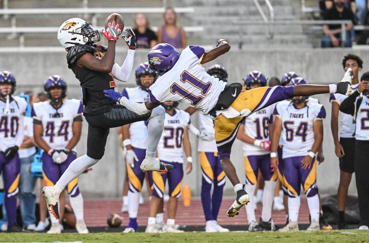 Clovis West’s Marshel Sanders, left, is unable to come up with the ball as the pass is broken up by Lemoore’s Kiontre Harris during their game at Veterans Memorial Stadium on Friday, Sept. 1, 2023.