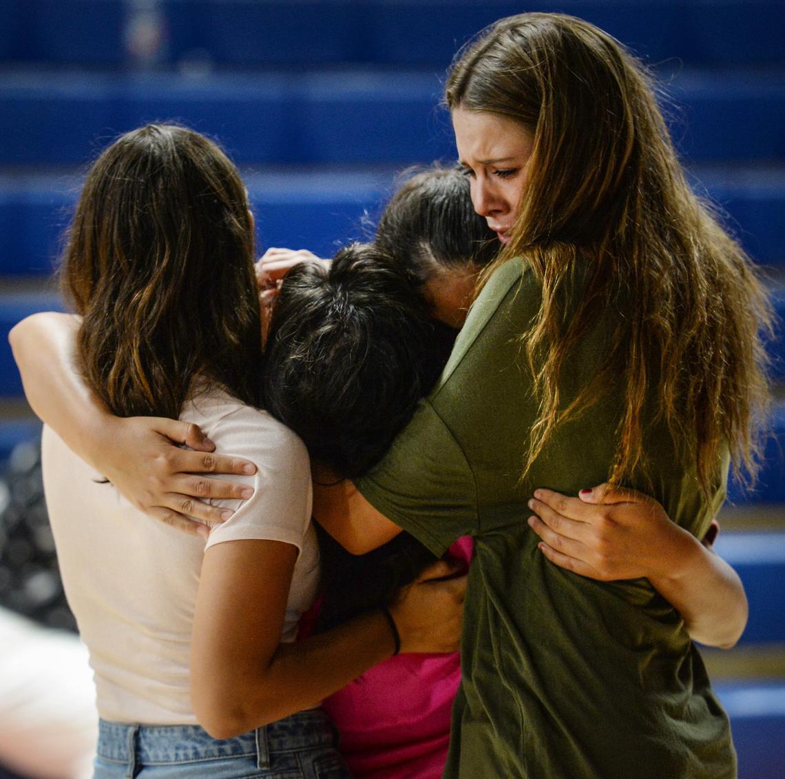 Students console each other during a prayer vigil for San Joaquin Memorial High School student Nick Kauls at the school's gym on Tuesday, June 26, 2018.