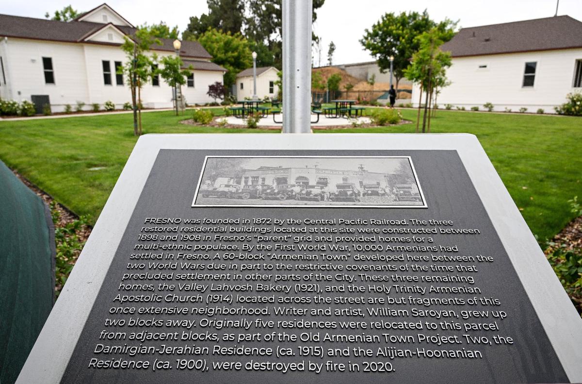 A plaque located on the lot where three 100-year-old Armenian homes have been restored as affordable housing tells how the Armenian Town neighborhood was established more than 100 years ago.