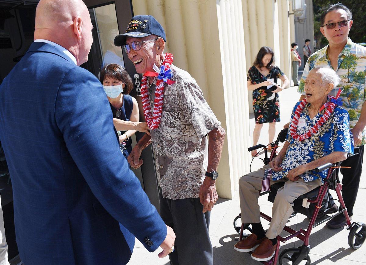 Fresno Mayor Jerry Dyer, left, greets Raymond Lee, center, and Wing Tuck Chin, far right, two of four Chinese American WWII veterans who received medals and recognition in a ceremony attended by about 150 family and supporters at the Veterans Memorial Museum Saturday morning, June 26, 2021 in Fresno.