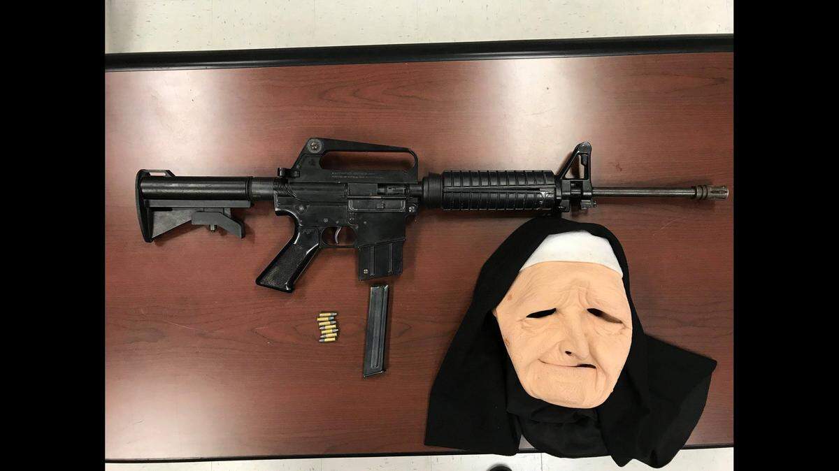 Police say three men armed with an assault rifle and carrying a nun mask were arrested Monday night in Madera.
