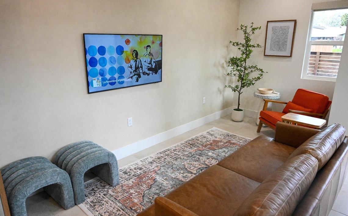 The living room space is shown at a recently completed accessory dwelling unit or ADU sitting adjacent to a house on a lot in Fresno neighborhood. Property owner Brandon Telesmanic had the home built as a rental property which is a growing trend in Fresno.