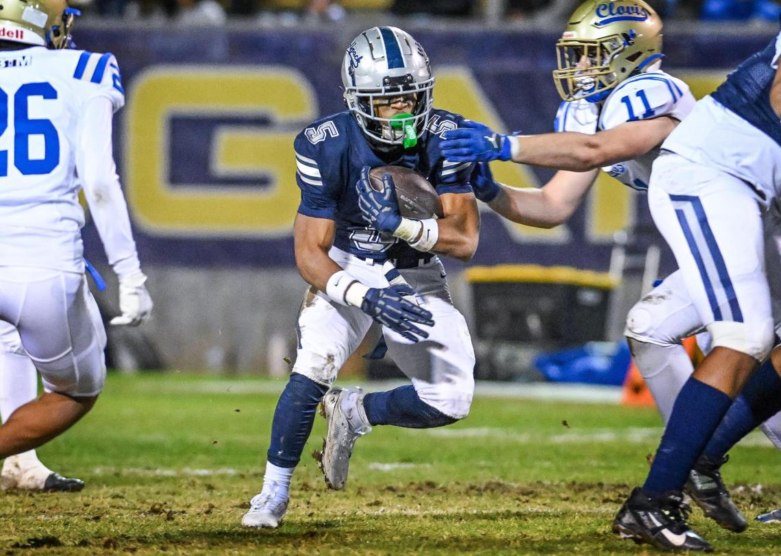 Clovis East’s Taemell Horton takes the ball on a carry up the middle during their Central Section Division 1-AA semifinal game against Clovis at Lamonica Stadium in Clovis on Friday, Nov. 15, 2024.