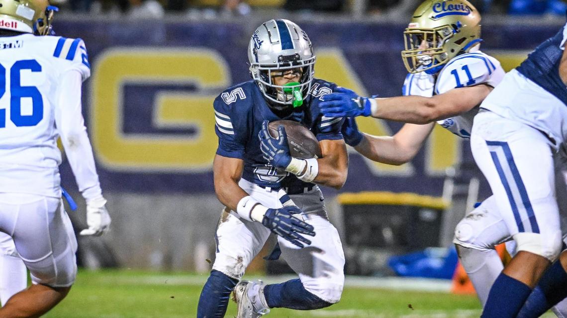 Clovis East’s Taemell Horton takes the ball on a carry up the middle during their Central Section Division 1-AA semifinal game against Clovis at Lamonica Stadium in Clovis on Friday, Nov. 15, 2024.