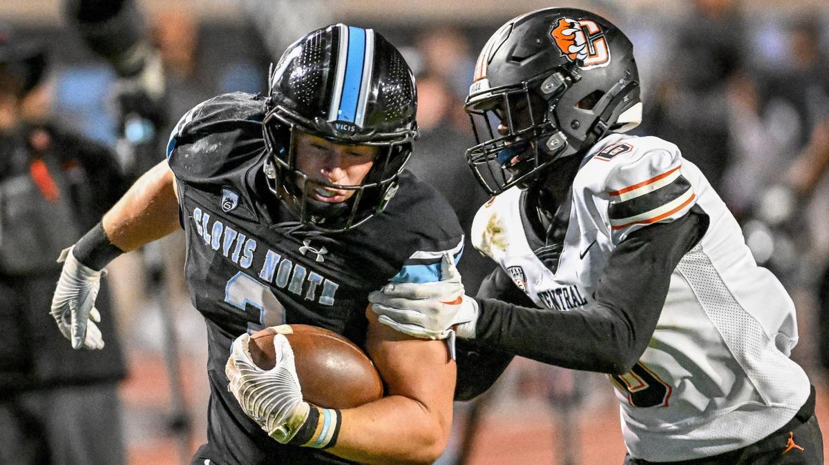 File photo of Clovis North running back McKay Madsen trying to pull away from Central’s Jaylon Jones before scoring the Bronco’s go-ahead touchdown late in their Central Section Division 1 football championship game at Veterans Memorial Stadium in Clovis on Friday, Nov. 24, 2023.