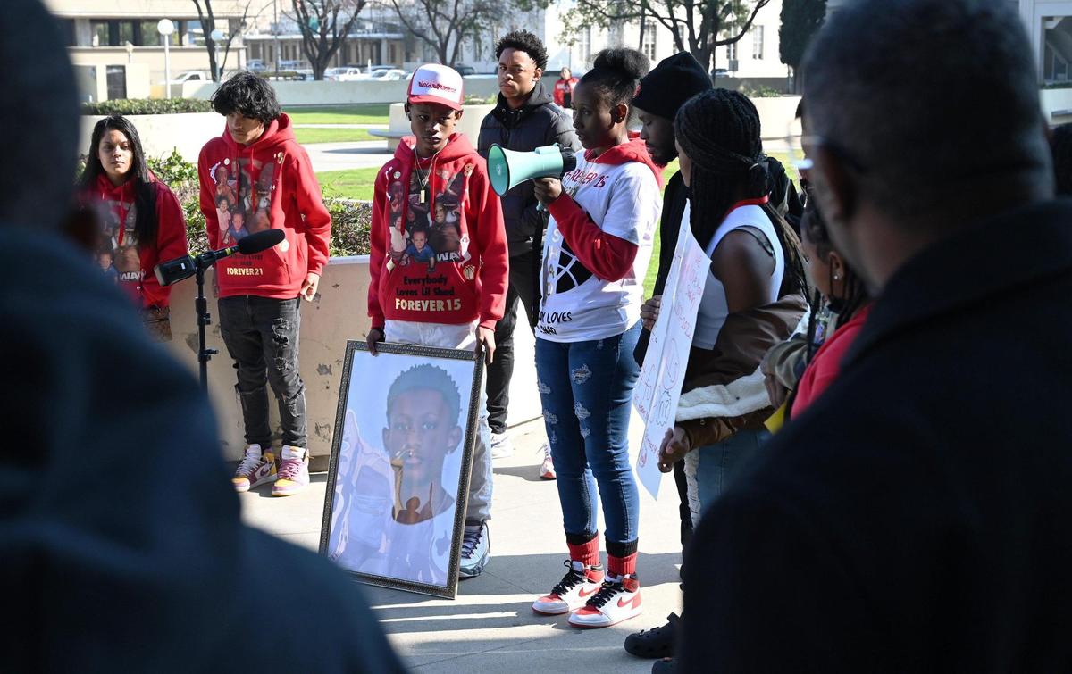 Rashad Al-Hakim Jr’s mother Regina Bell, in center with bullhorn, speaks to those gathered at a rally demanding justice outside the Fresno County Courthouse Monday morning, Jan. 23, 2023 in Fresno. Bell’s son Rashad Al-Hakim Jr. is the 15-year old Hoover High School student killed in a hit and run Oct. 4, 2022. The accused driver, Lisa Ellen Spoors, received reduced bail and left jail January 19.