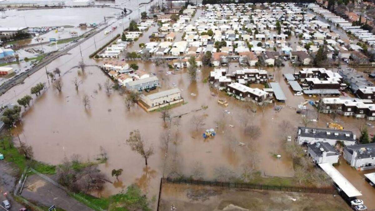 Water surrounds a neighborhood in western Merced after Bear Creek overflowed its banks during a Jan. 10, 2023 storm.