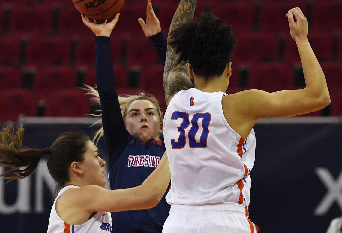 Fresno State guard Haley Cavinder, center, takes a shot guarded by Boise State’s Cristina Gil, left, and Jade Loville, right, in the Bulldogs’ 92-57 victory Thursday, Jan. 21, 2021 in Fresno.