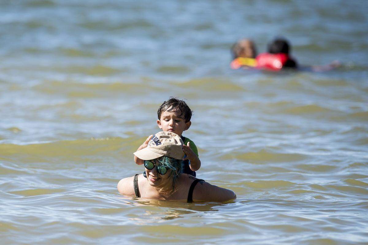 Casandra Maravilla, of Merced, floats with her nephew Joaquin Souza on her back at Lake Yosemite in Merced on a hot day in June 2017.