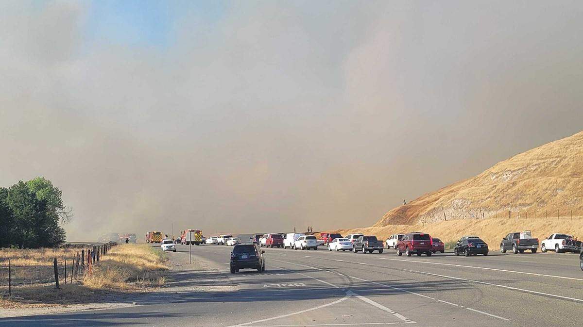 A grass fire forced the closure of Friant Road between Willow Avenue and Lost Lake Road on Sunday, June 27, 2021.