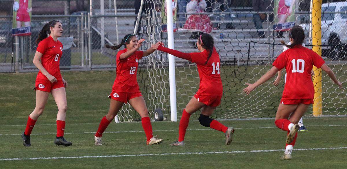 Sanger High’s Karina González celebrates a goal in the 75th minute with teammate Diana García as the Apaches won the CIF Central Section Division II championship with a 2-0 win over visiting San Luis Obispo.