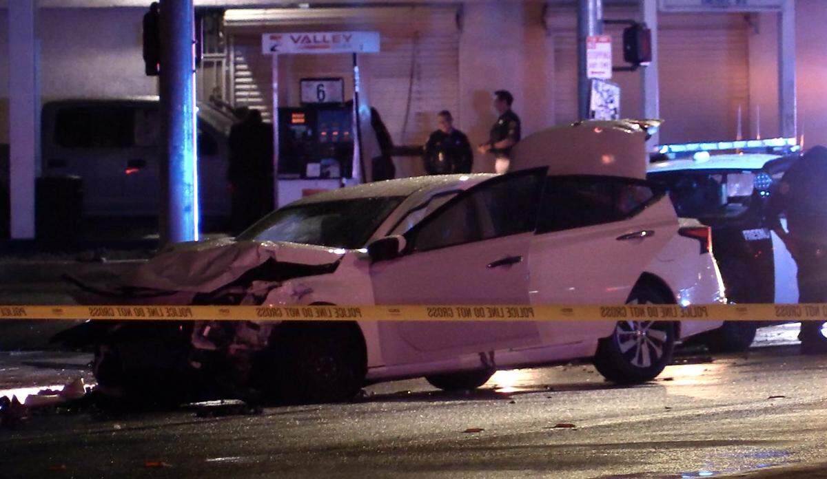 A white vehicle with four occupants, following a shooting at East Tyler Avenue, near Peach avenue crashes at Peach and Olive avenues on Thursday, May 4, 2023.