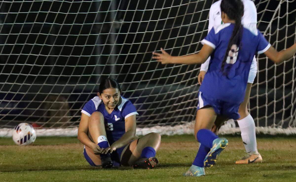 Caruthers High senior Gizelle Aguirre ties her shoelaces after scoring one of her four goals in the CIF Central Section Division VI soccer championship match at home against Riverdale High on Feb. 23, 2024. Caruthers won, 6-2.