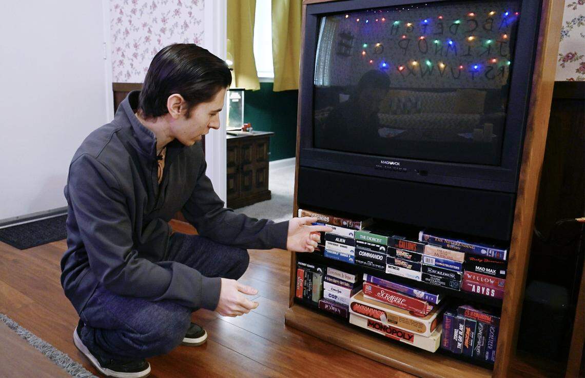 Chris Lofing shows the 1980's-era VHS tapes available to guests at the Stranger Things-themed Airbnb house in Clovis. Photographed Tuesday, Jan. 13, 2026 in Clovis.