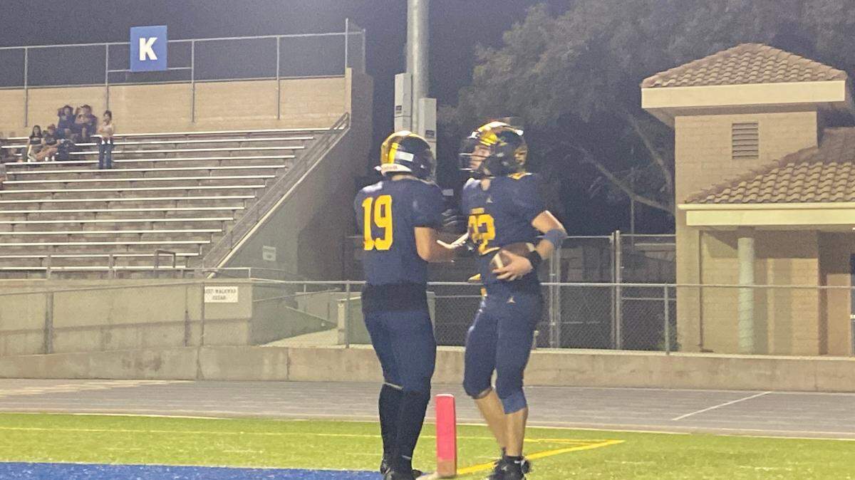 Tanner Wilson, right, is congratulated by Angel Hernandez, left, after scoring a touchdown on Thursday, Sept. 5, 2024. The Wildcats defeated Ridgeview 33-0.