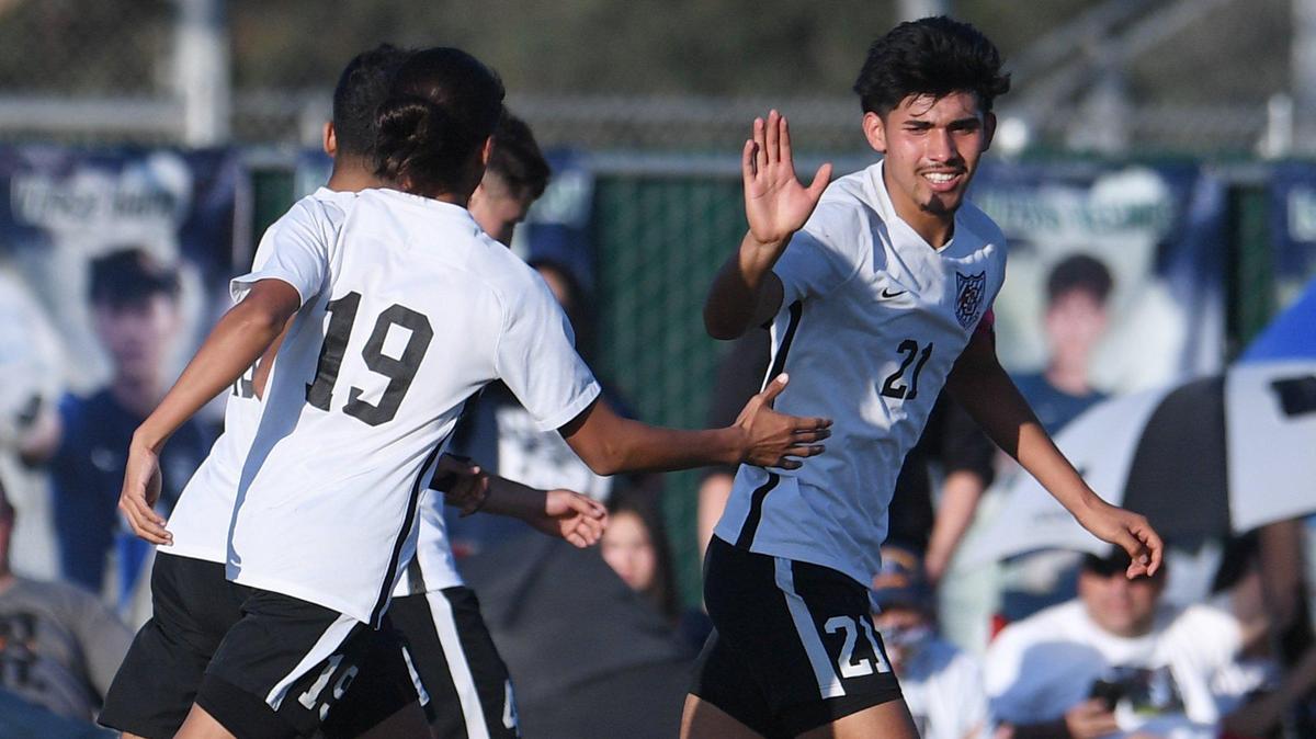 Central’s Jesus Rodriguez, 21, high-fives Joel Michel against Clovis East in the Tri-River Athletic boys soccer finale on Friday, Feb. 11, 2022. Central defeated Clovis East 2-1 as both teams finish as TRAC co-champions.