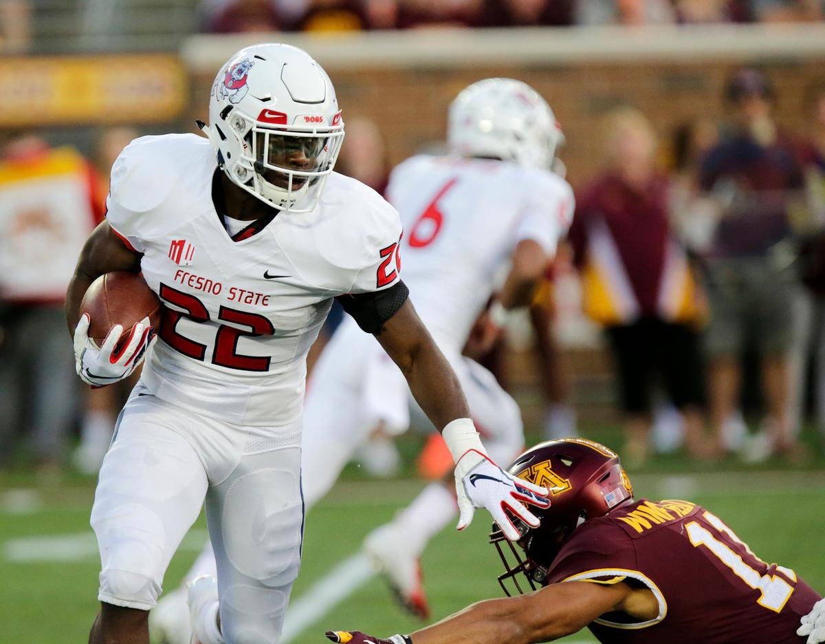 Fresno State running back Jordan Mims (22) runs past Minnesota’s Antoine Winfield Jr. (11) in the first quarter of the Bulldogs’ 21-14 loss to the Golden Gophers, Saturday, Sept. 8, 2018, in Minneapolis. Mims led the Bulldogs with 41 rushing yards on 10 plays.