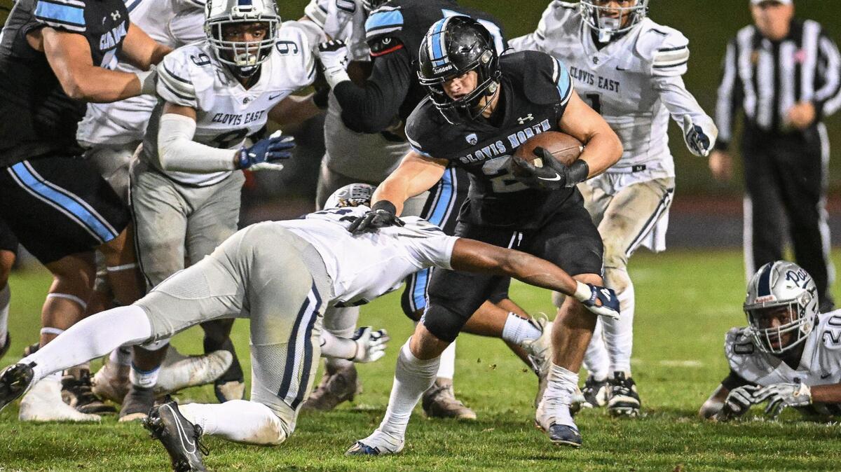 Clovis North’s Jackson Cinfel tries to find room to run in the backfield against Clovis East in their Central Section Division I semifinal at Veterans Memorial Stadium on Friday, Nov. 17, 2023.