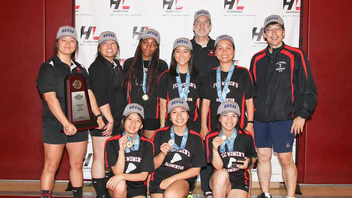 Fresno City College coach Panhia Vang with the championship trophy in directing Fresno City College to the 2019 state badminton title.