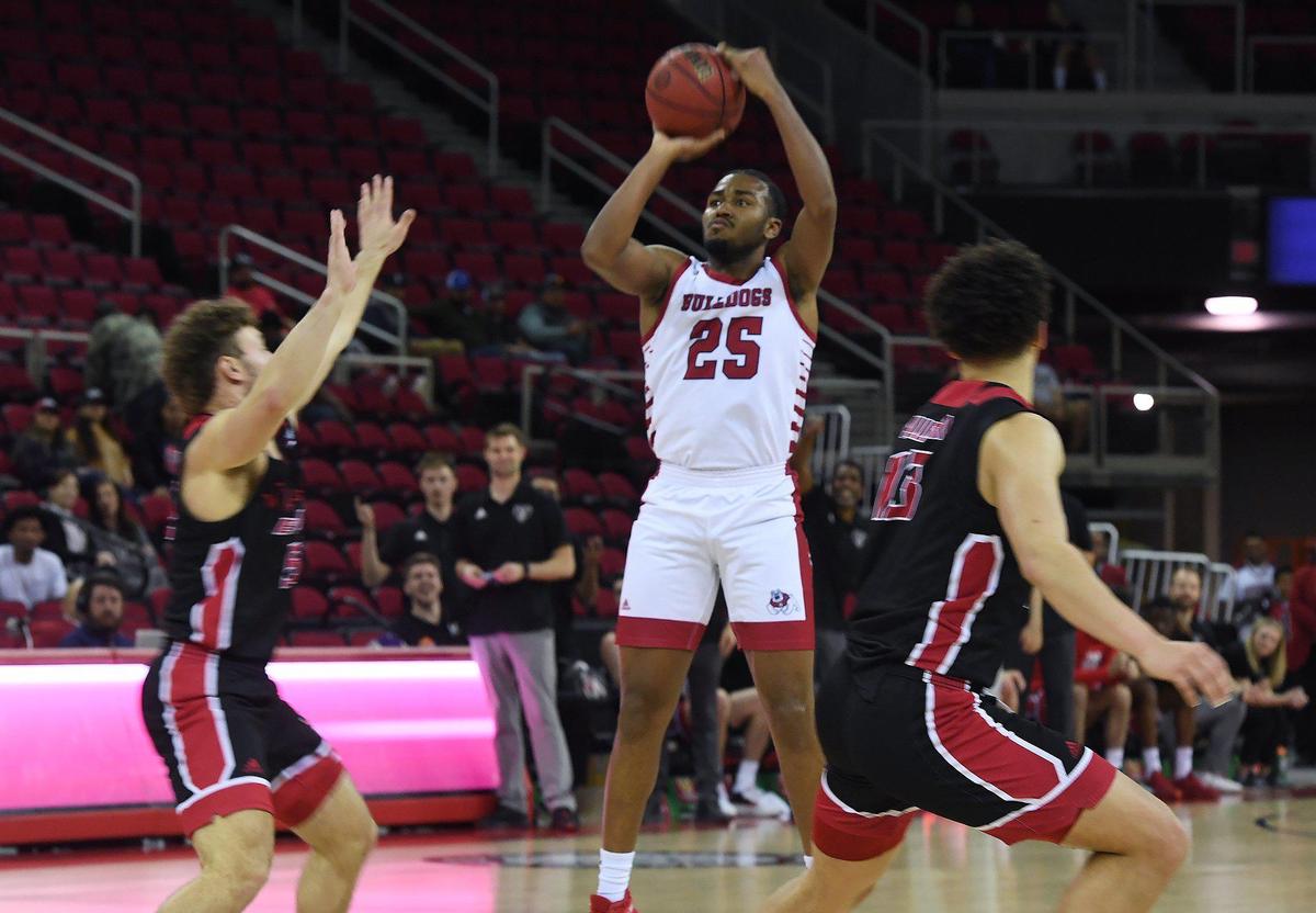 Fresno State’s Anthony Holland, center, takes aim with Eastern Washington’s Ellis Magnuson to the left in The Basketball Classic Thursday, March 17, 2022 in Fresno. The Bulldogs won 83-74.