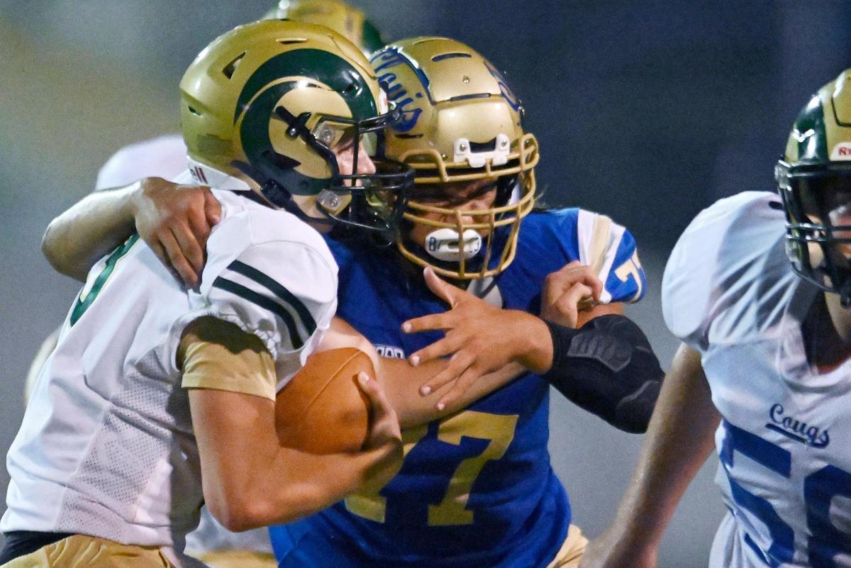 Clovis High’s Logan Cordero, right, sacks Garces quarterback Gunter Golla, left, Thursday, Aug. 17, 2023 in Clovis.