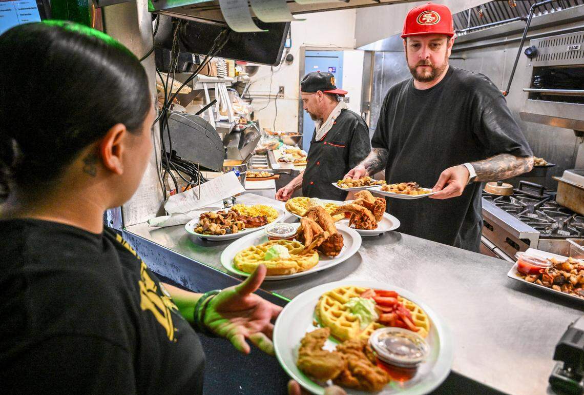 Cook Michael Peach serves up brunch dishes from the kitchen at Kocky's Bar & Grill during their Butta Brunch on Sunday, Aug. 10, 2025.