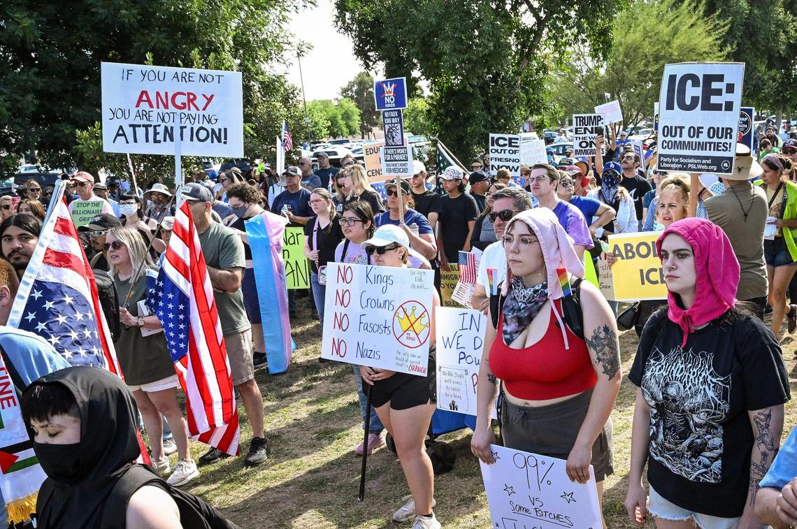 Protesters gather for a rally at Cary Park near Fashion Fair Mall in Fresno before marching toward Shaw Avenue for a “No Kings” protest against President Donald Trump’s policies on Saturday, June 14, 2025.