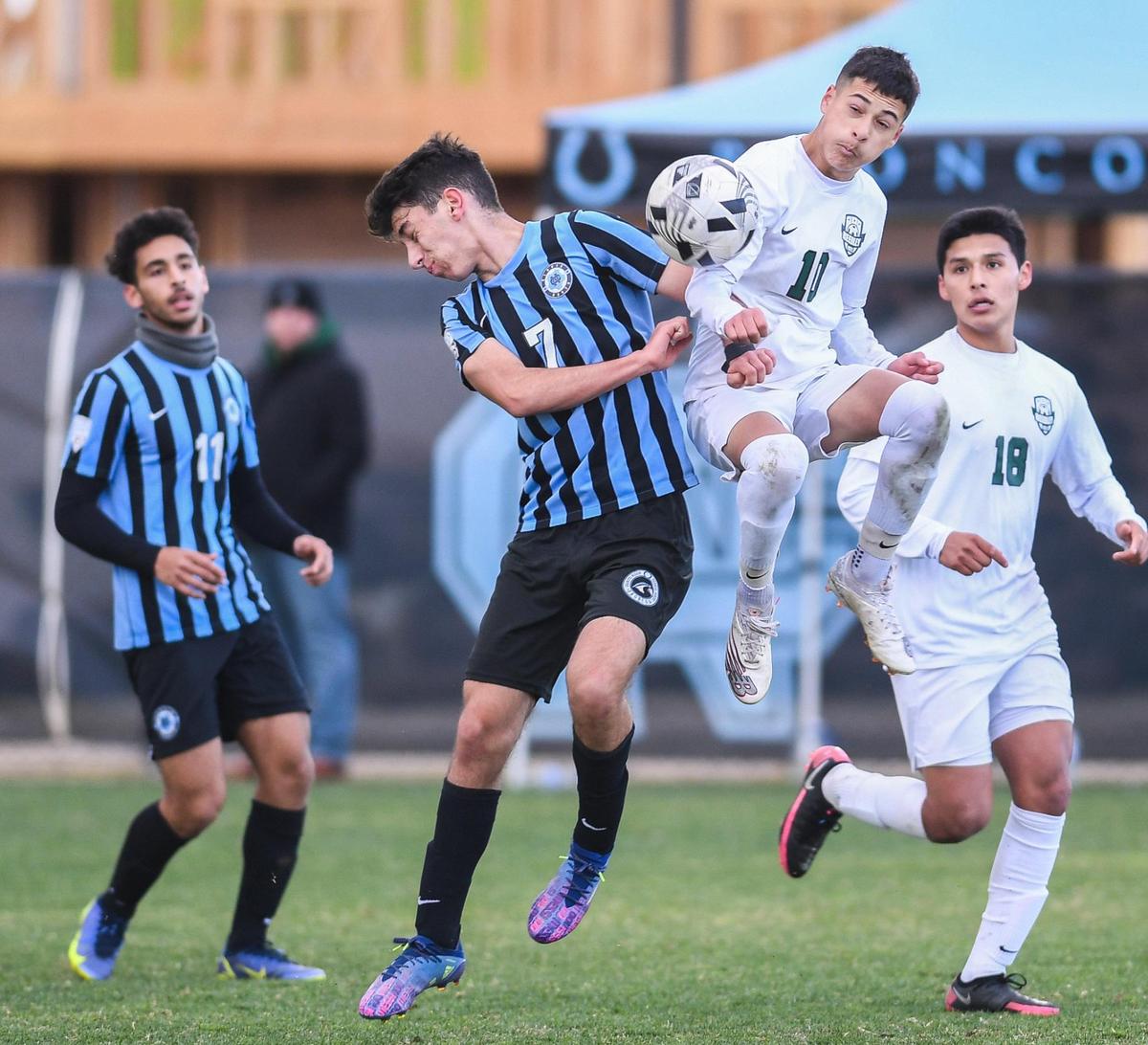 Clovis North’s Samuel Gevorgyan, left, battles Esteban Baca for the ball during their match at Clovis North on Tuesday, Feb. 22, 2022.