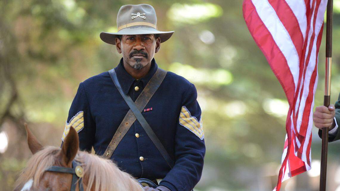 Yosemite National Park ranger Shelton Johnson wears the uniform of a Buffalo Soldier while saddled on his horse during the Yosemite Grant sesquicentennial ceremony at Yosemite National Park’s Mariposa Grove Monday, June 30, 2014. On June 30, 1864, President Abraham Lincoln signed the Yosemite Land Grant which eventually led to the national parks system. CRAIG KOHLRUSS