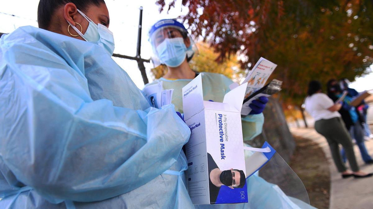 Health care workers wait to offer COVID-19 testing at Cristo Rey Church Friday afternoon, Nov. 20, 2020 in Malaga, south of Fresno.
