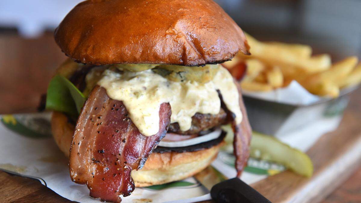 Mad Duck’s jalapeño burger with applewood bacon and fries, at the new location at Herndon and Marks avenues.