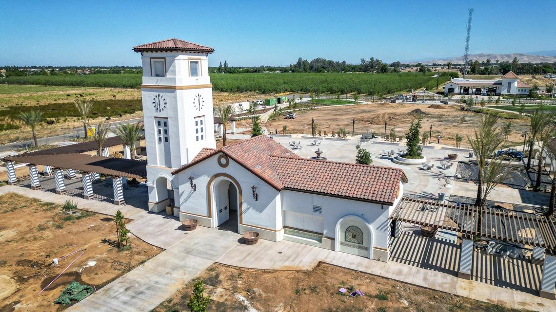 A clock tower marks a landmark entrance to the Village Green, a seven-acre park under construction in Clovis’ Loma Vista Urban Center, photographed on Wednesday, May 29, 2024.