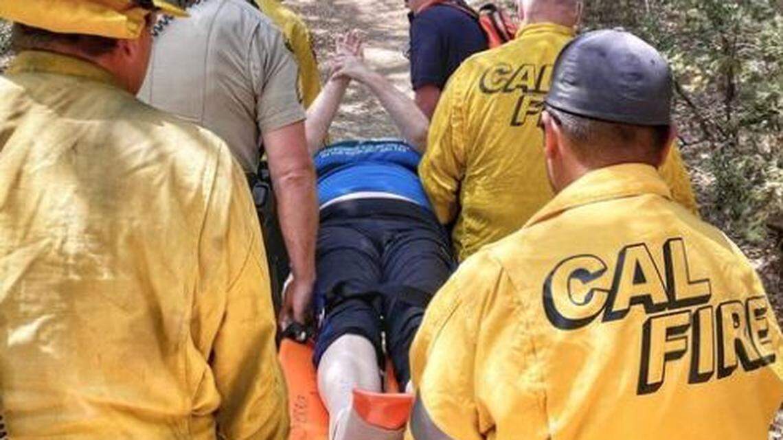 Emergency workers render aid to a hiker who broke her ankle near Angel Falls in Madera County on Friday, July 23, 2021.